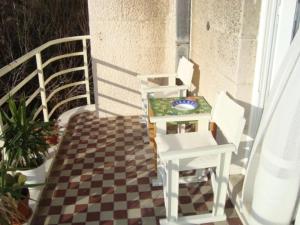 a patio with a table and chairs on a balcony at Riki in Split