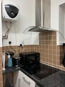 a kitchen with a stove top oven in a kitchen at Lovely 2 bed flat in SOHO! in London