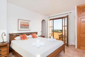 a bedroom with a large white bed and a balcony at Villa Xoric by Villa Plus in Son Xoriguer +35 photos
