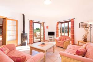 a living room with two couches and a fireplace at Villa Xoric by Villa Plus in Son Xoriguer