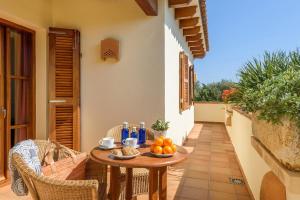 a table on a balcony with fruit on it at Villa Xoric by Villa Plus in Son Xoriguer