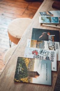 a wooden table with books on top of it at Gîte La Source in Grusse