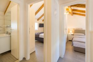 Postel nebo postele na pokoji v ubytování Olive Garden Apartment