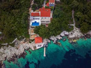 an aerial view of a house on an island in the water at Villa Ragusea With a Private Beach in Slano