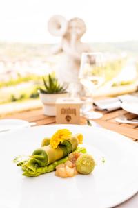 une assiette de nourriture sur une table avec un verre de vin dans l'établissement Schlosshotel Steinburg, à Wurtzbourg