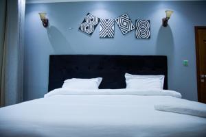 Posteľ alebo postele v izbe v ubytovaní IGITEGO APARTHOTEL LTD