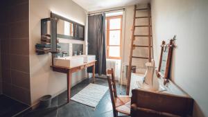 a bathroom with a sink and a mirror and a ladder at Gîte La Source in Grusse