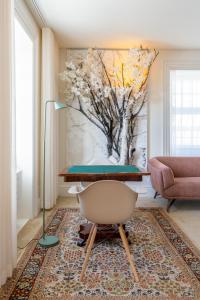 a living room with a table and a tree mural at FONTE SANTA Manor House in Vila Nova de Gaia