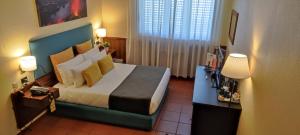 Postel nebo postele na pokoji v ubytování Corsaro Etna Hotel&SPA