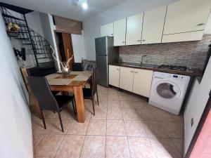 a kitchen with a table and a washing machine at Casa Ambrosia Tropea in Tropea +8 photos
