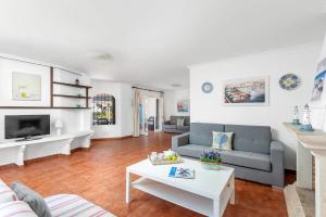 a living room with a couch and a table at Villa Mercedes by Villa Plus in Cala en Forcat