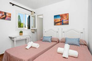 a bedroom with two beds with towels on them at Villa Mercedes by Villa Plus in Cala en Forcat +27 photos