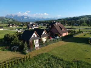 an aerial view of a house in a green field at Strefa Hawrań in Jurgów