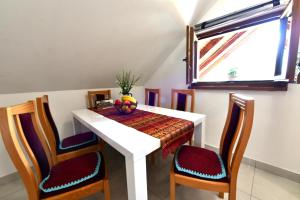 a dining room table with a bowl of fruit on it at Apartman Jelena in Rakovica