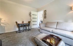 a living room with a couch and a table at Cozy Apartment In Surhuisterveen in Surhuisterveen