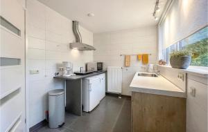 a kitchen with a sink and a counter top at Cozy Apartment In Surhuisterveen in Surhuisterveen