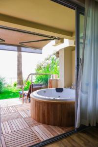 a jacuzzi tub on the deck of a house at Melas Resort Hotel in Side