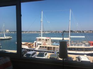 a large boat is docked in a harbor at Apartment Bellavista - Umag in Umag