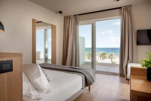 a bedroom with a bed and a view of the ocean at Hotel San Marco in Cattolica
