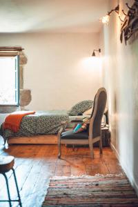 a bedroom with a bed and a chair in a room at Gîte La Source in Grusse