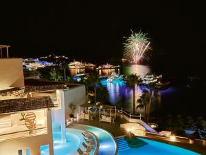 a view of a resort at night with fireworks at Mykonos Blu, A Grecotel Resort to Live in Psarou