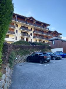 ein Parkplatz mit Autos vor einem Gebäude in der Unterkunft Studio magnifique saint Gervais les bains in Saint-Gervais-les-Bains