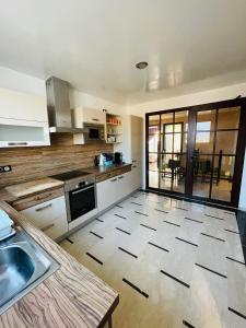 a kitchen with a sink and a counter top at Very nice apartment near the city center & beach in Agadir