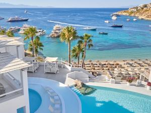 a view of the beach and the ocean from a resort at Mykonos Blu, A Grecotel Resort to Live in Psarou