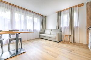 a living room with a couch and a table at Chalet Graben in Grindelwald