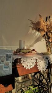 a table with a cake and a candle on it at Pansion Katerina in Ouranoupoli
