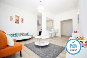 a living room with an orange chair and a table at B50 - Main Square Apartment in Lagos in Lagos