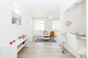 a white living room with white desks and chairs at B50 - Main Square Apartment in Lagos in Lagos