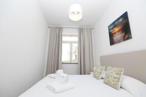 a bedroom with a white bed and a window at B50 - Main Square Apartment in Lagos in Lagos