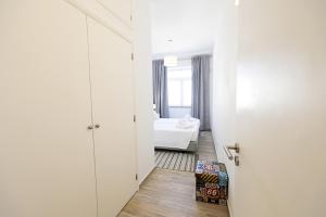 a corridor of a room with a bed and a door at B50 - Main Square Apartment in Lagos in Lagos