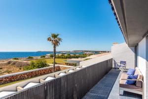 a balcony with chairs and a view of the ocean at Villa Sea View by Villa Plus in Sa Caleta