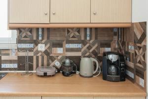a kitchen counter with various appliances on it at Hillside Seaview Apartment in Stalos