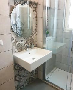 a bathroom with a sink and a mirror and a shower at Sweet Holidays al centro di Formia in Formia