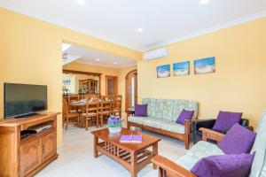 a living room with a couch and a tv at Villa Manuel by Villa Plus in Son Parc