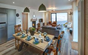 a living room with a table and a couch at 5 Bedroom Cottage - Llyn Peninsula in Pistyll