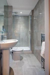 a bathroom with a toilet and a sink and a shower at 5 Bedroom Cottage - Llyn Peninsula in Pistyll +8 photos