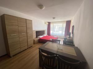 a room with a dining table and a bedroom at Sunrise Apartments, Pomorie in Pomorie