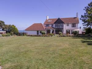 a house with a large lawn in front of it at Pentire House in Deal