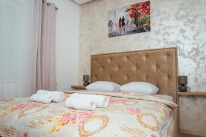 a bedroom with a bed with towels on it at La Mer Apartments Kotor in Kotor +45 photos