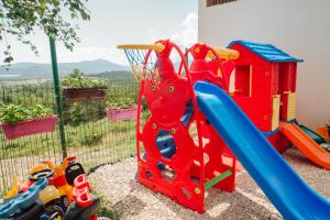 a childs play set with a playground equipment at La Mer Apartments Kotor in Kotor