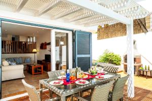 a dining table and chairs on a patio at Villa Isabella by Villa Plus in Corralejo