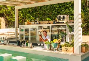 a man is taking a picture of a counter with food at Resort Miramonti in Forte dei Marmi