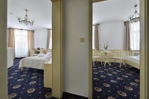 A bed or beds in a room at Hotel Podhrad