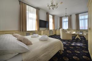 A bed or beds in a room at Hotel Podhrad