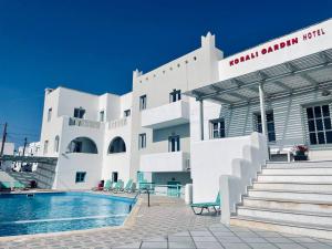 a building with a swimming pool in front of a building at Korali Garden in Naxos Chora