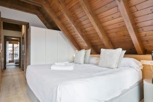 A bed or beds in a room at Luderna - Apartamento Arties era Cabaneta